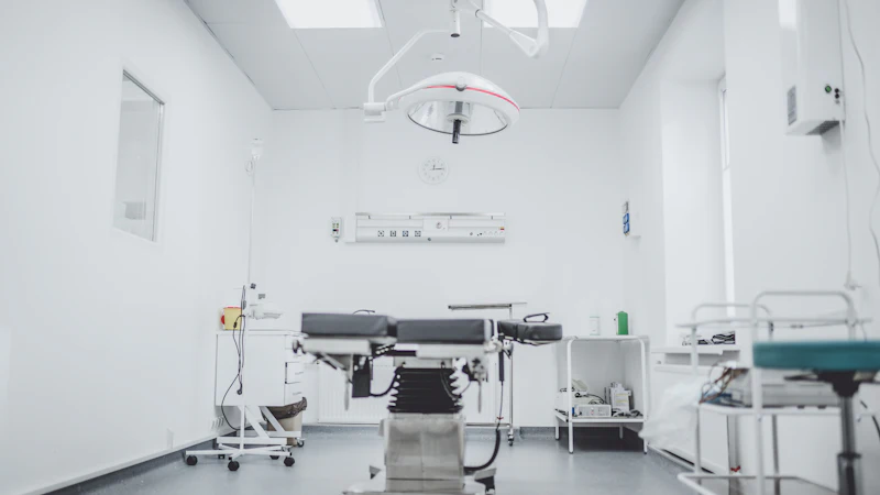 An empty operating room with its table and lights, before decommissioning