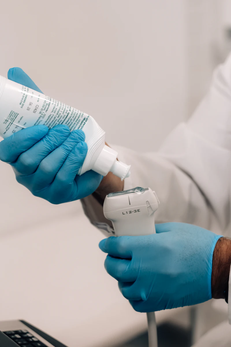 Gloved hands holding an ultrasound transducer during cleaning
